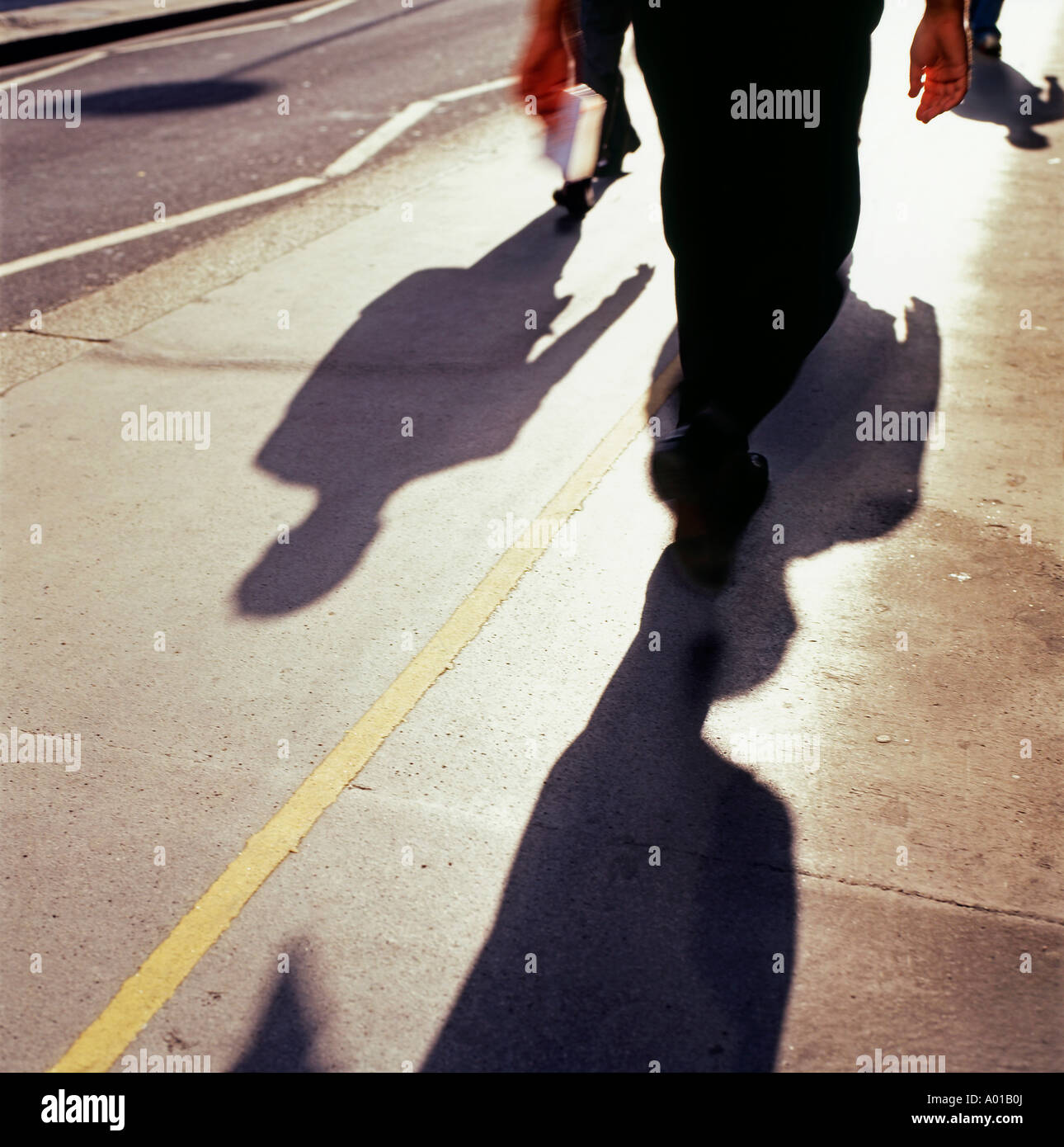 Shadow of people walking on pavement London England UK  KATHY DEWITT Stock Photo