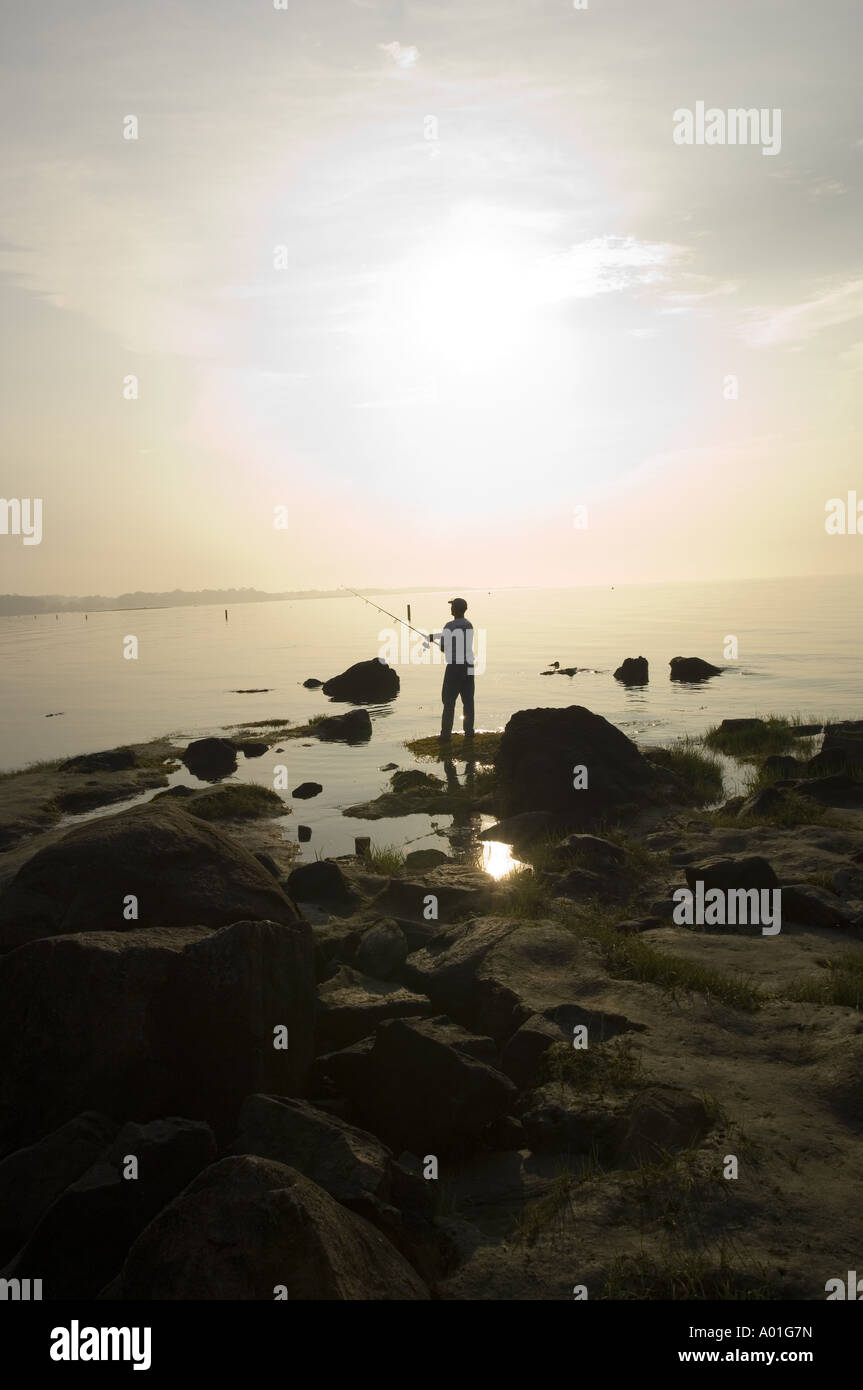 Fisherman silhouette at sunrise Stock Photo - Alamy