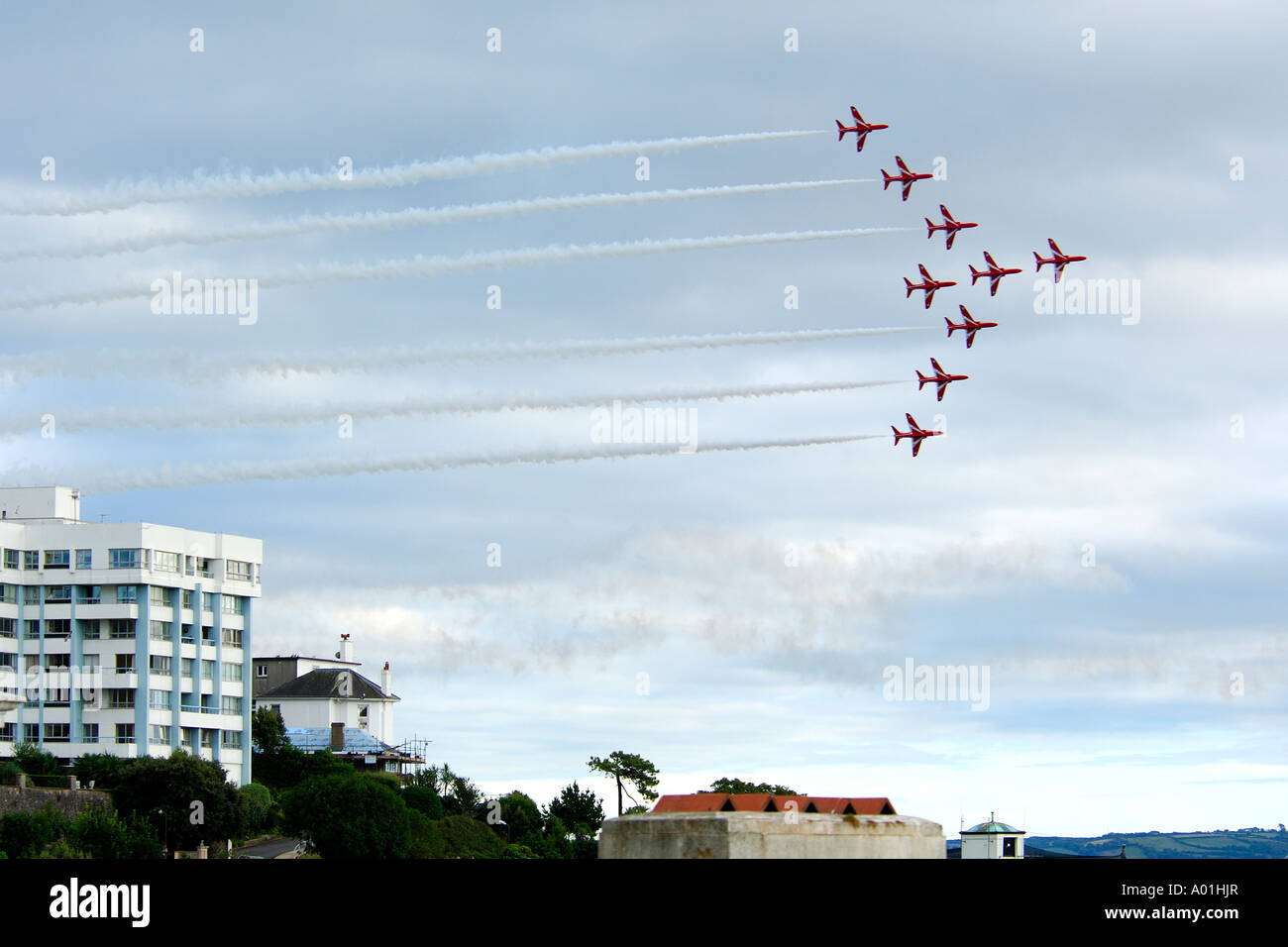 Royal Air Force Red Arrow aerobatic display over Torquay harbour with overcast weather conditions August 2006 Stock Photo