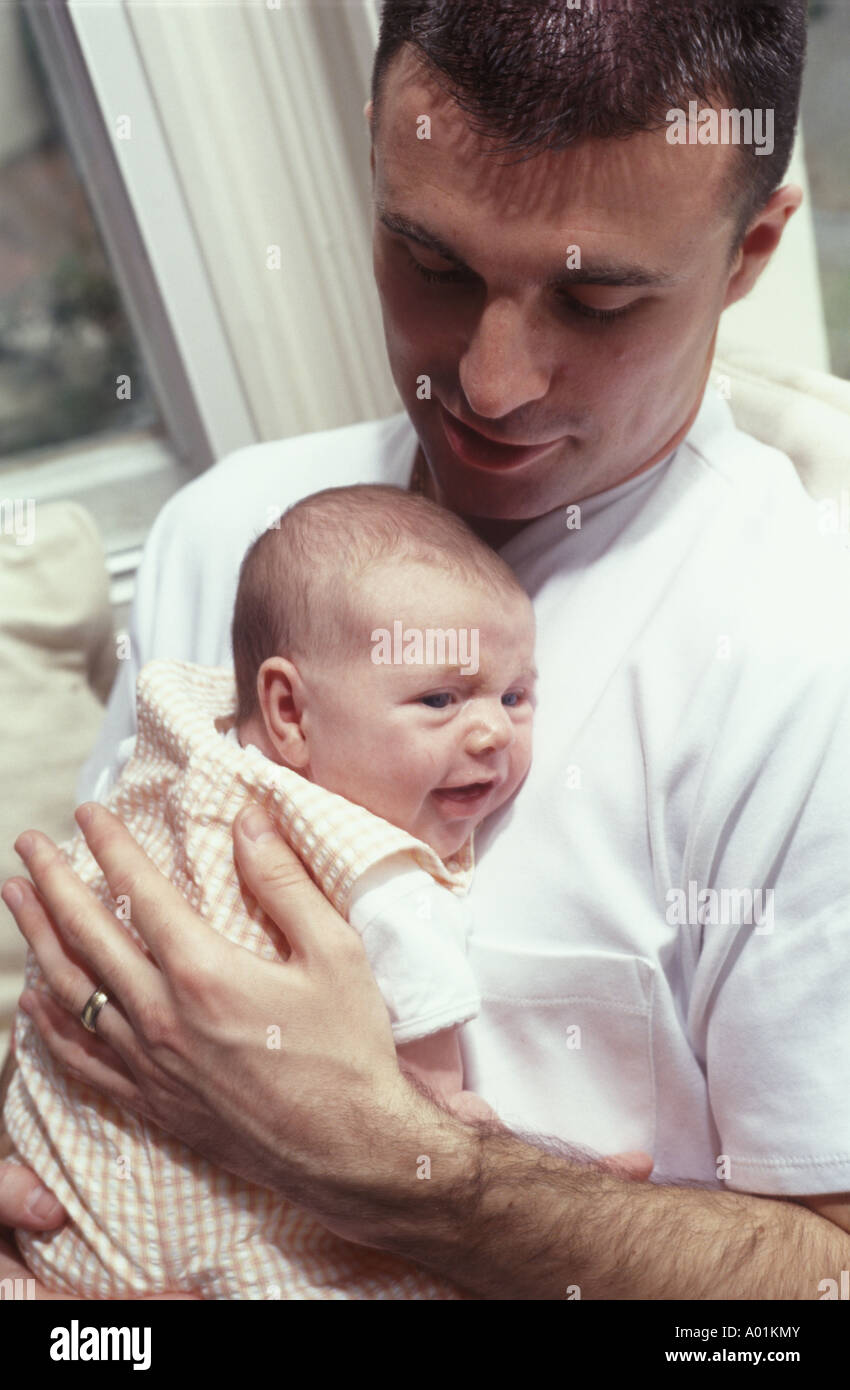 man holding baby close Stock Photo