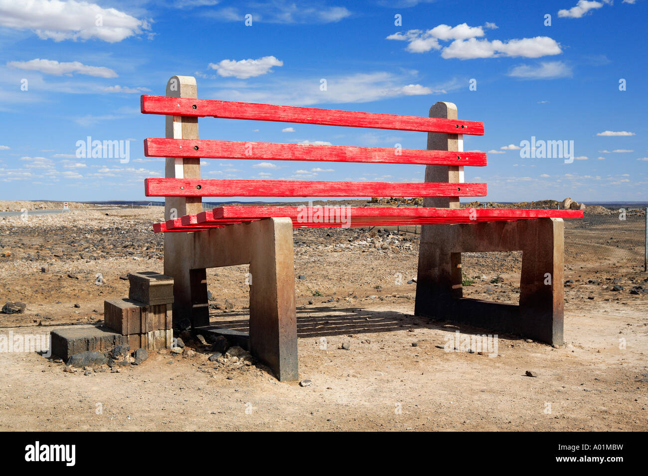Large red Park Bench public artwork, on top of the Line of Lode, Broken Hill, nsw Australia Stock Photo