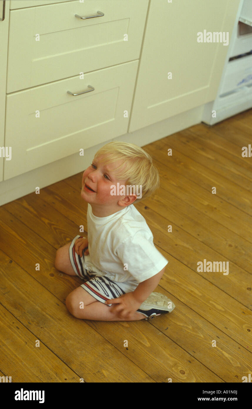 toddler having a tantrum on the kitchen floor Stock Photo Alamy