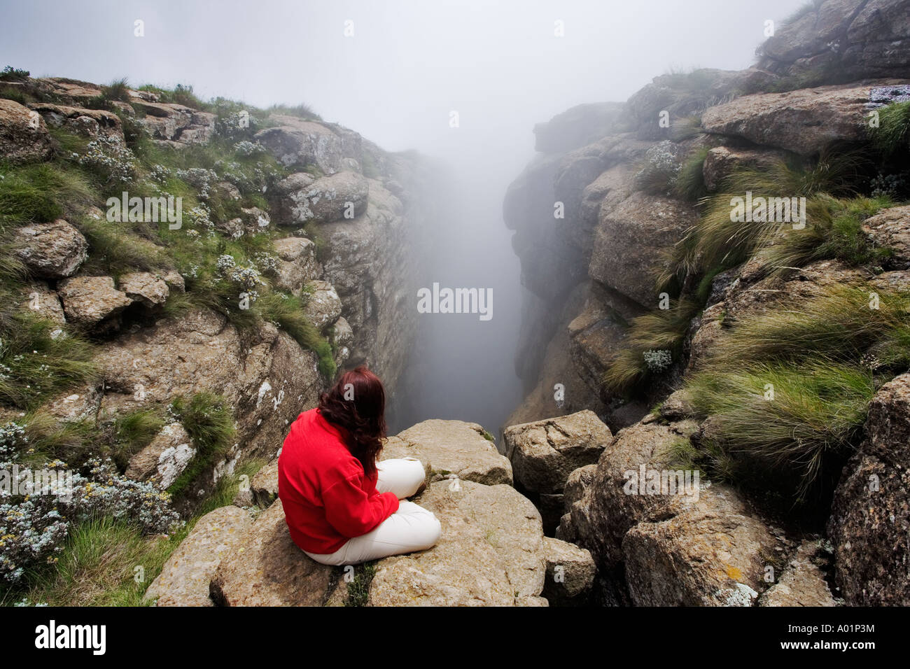 Hiker enjoying the beautiful misty mountain view on a hiking trail in the Drakensberg South Africa Stock Photo