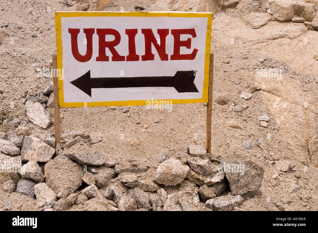 Sign with Urine word and arrow with dry rocky desert background Ladakh