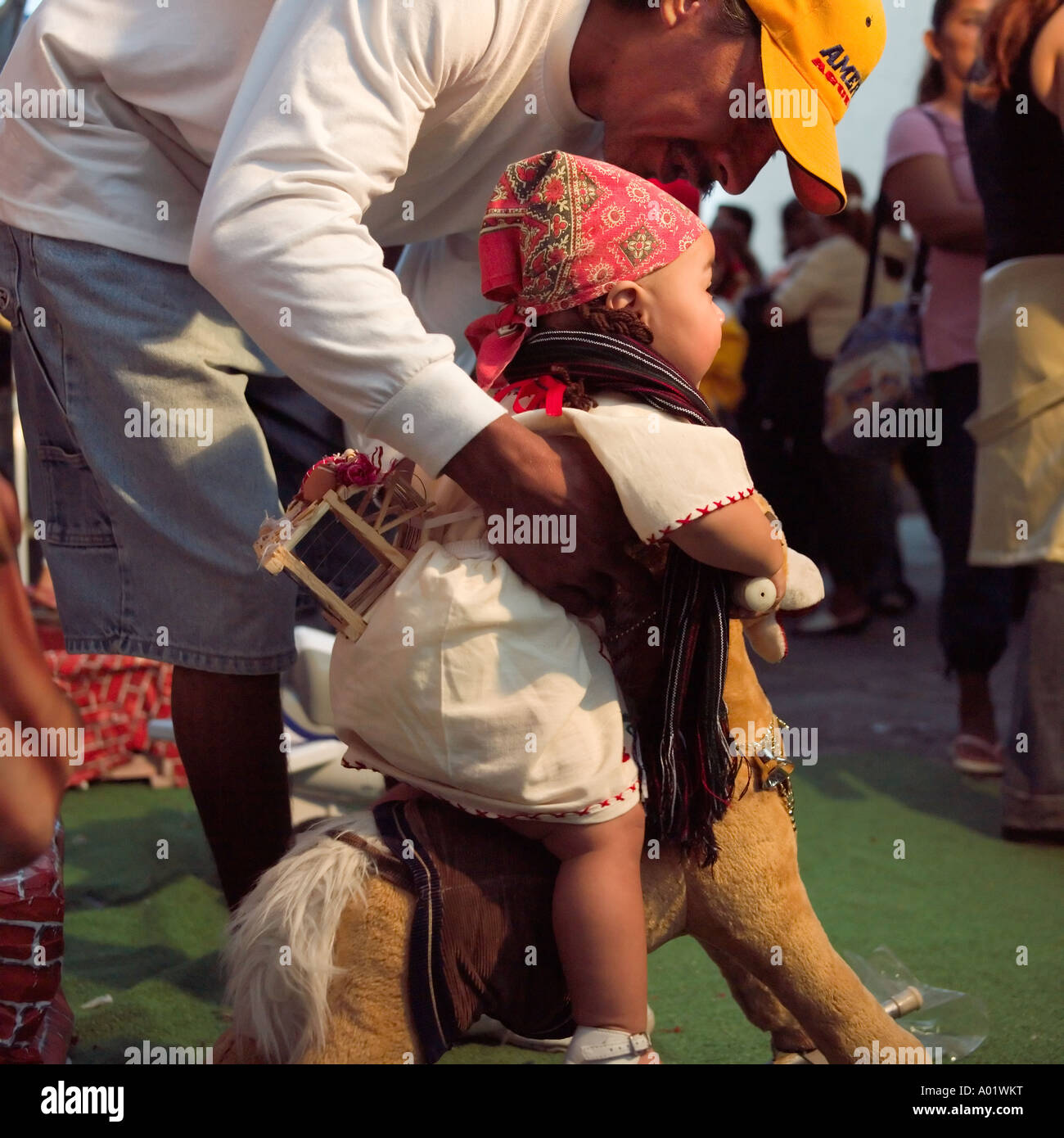 Tiny baby girl dressed in costume at the fiesta of the day of The Virgin Mazatlan Sinaloa Mexico Stock Photo
