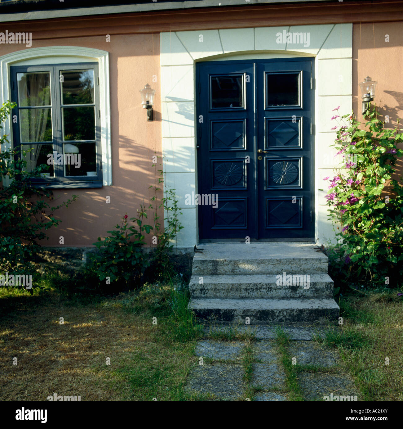 Steps Up To Black Doors Of Small Swedish Country House Stock Photo
