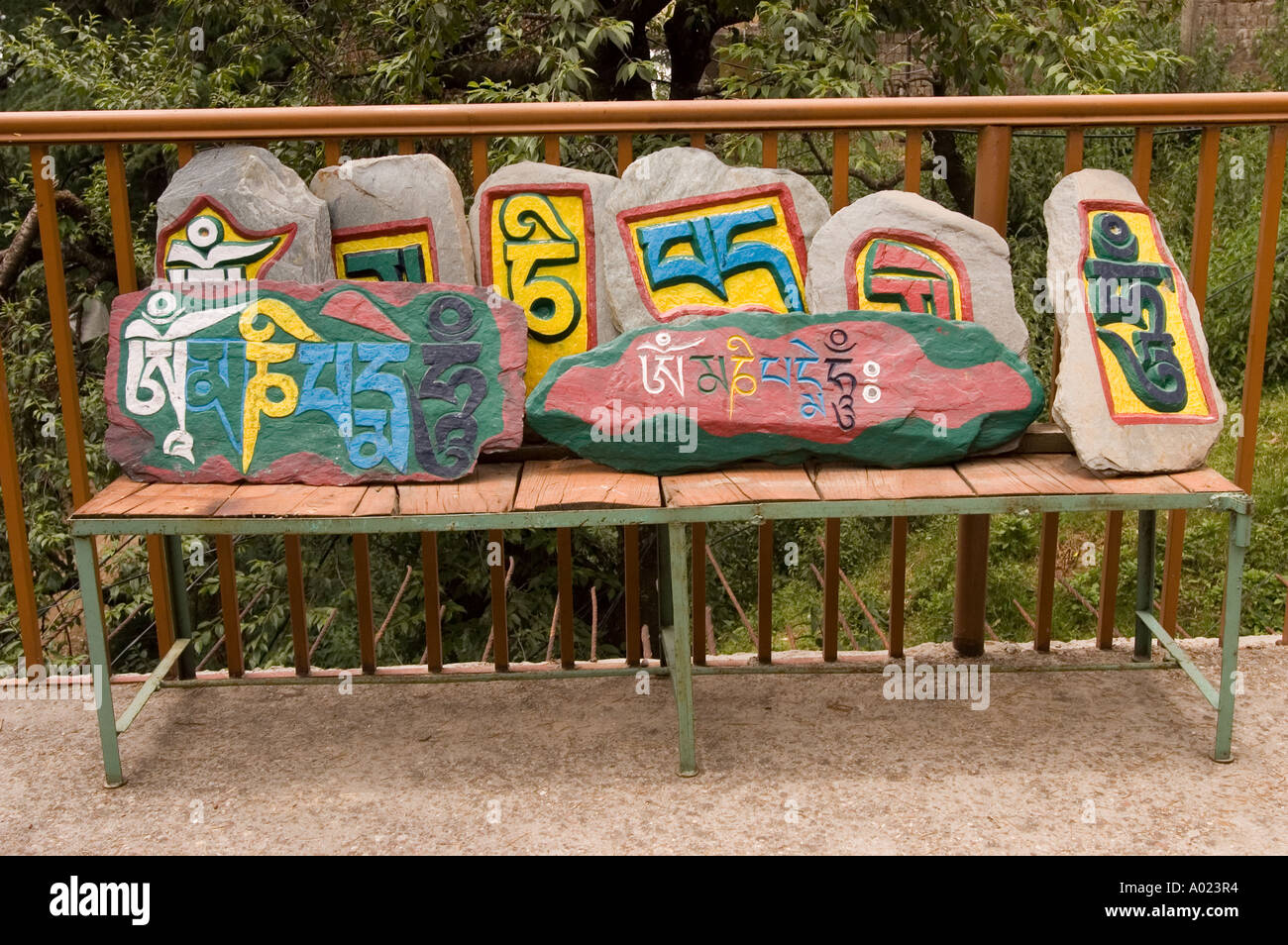 Colorful Mani stones with Tibetan inscriptions on a wooden bench in Dharamsala, Himachal Pradesh, India. Stock Photo