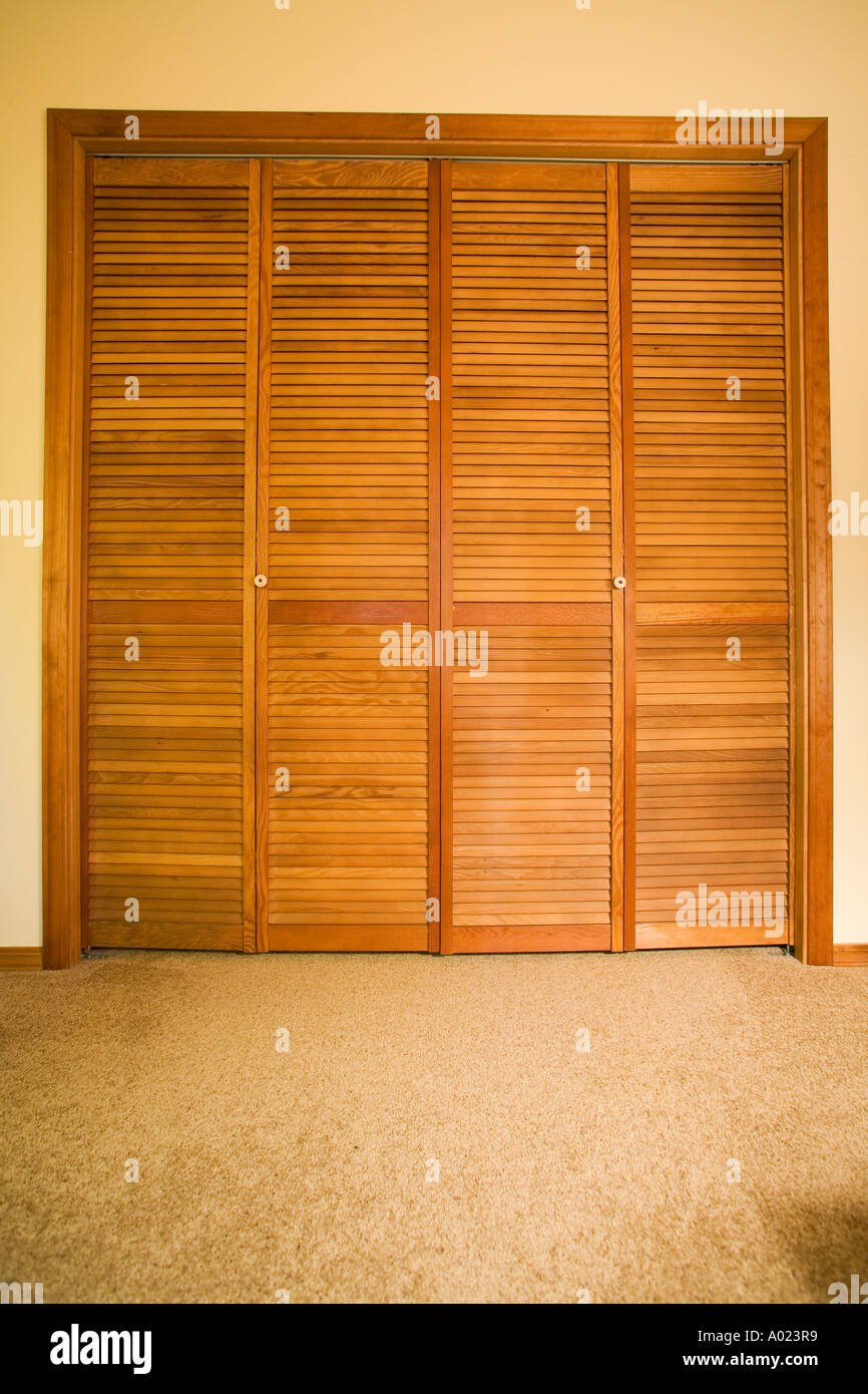 louvered wooden closet doors with ivory porcelain knobs Stock Photo Alamy