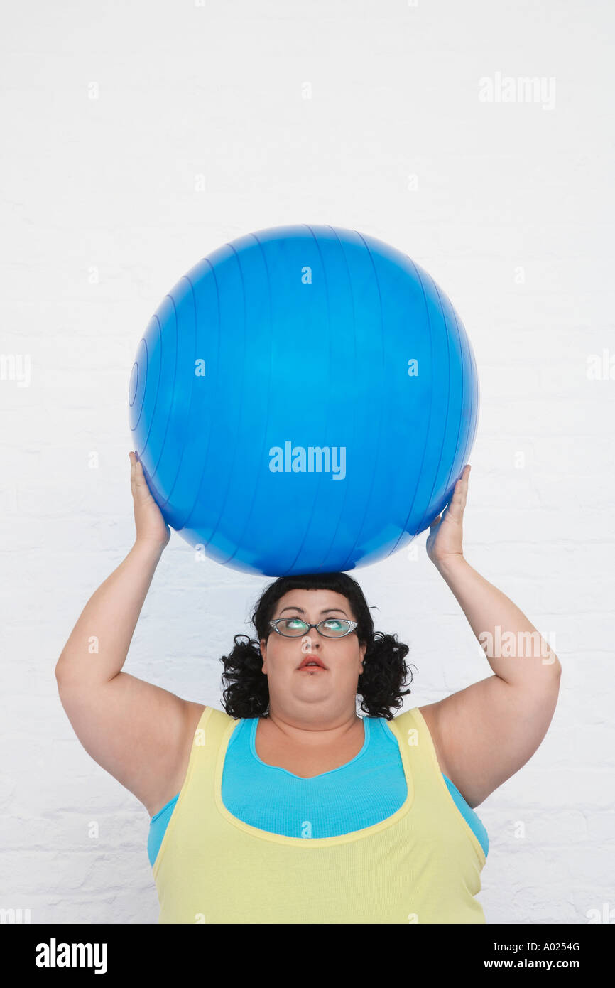 Overweight Woman Holding Exercise Ball on head Stock Photo Alamy
