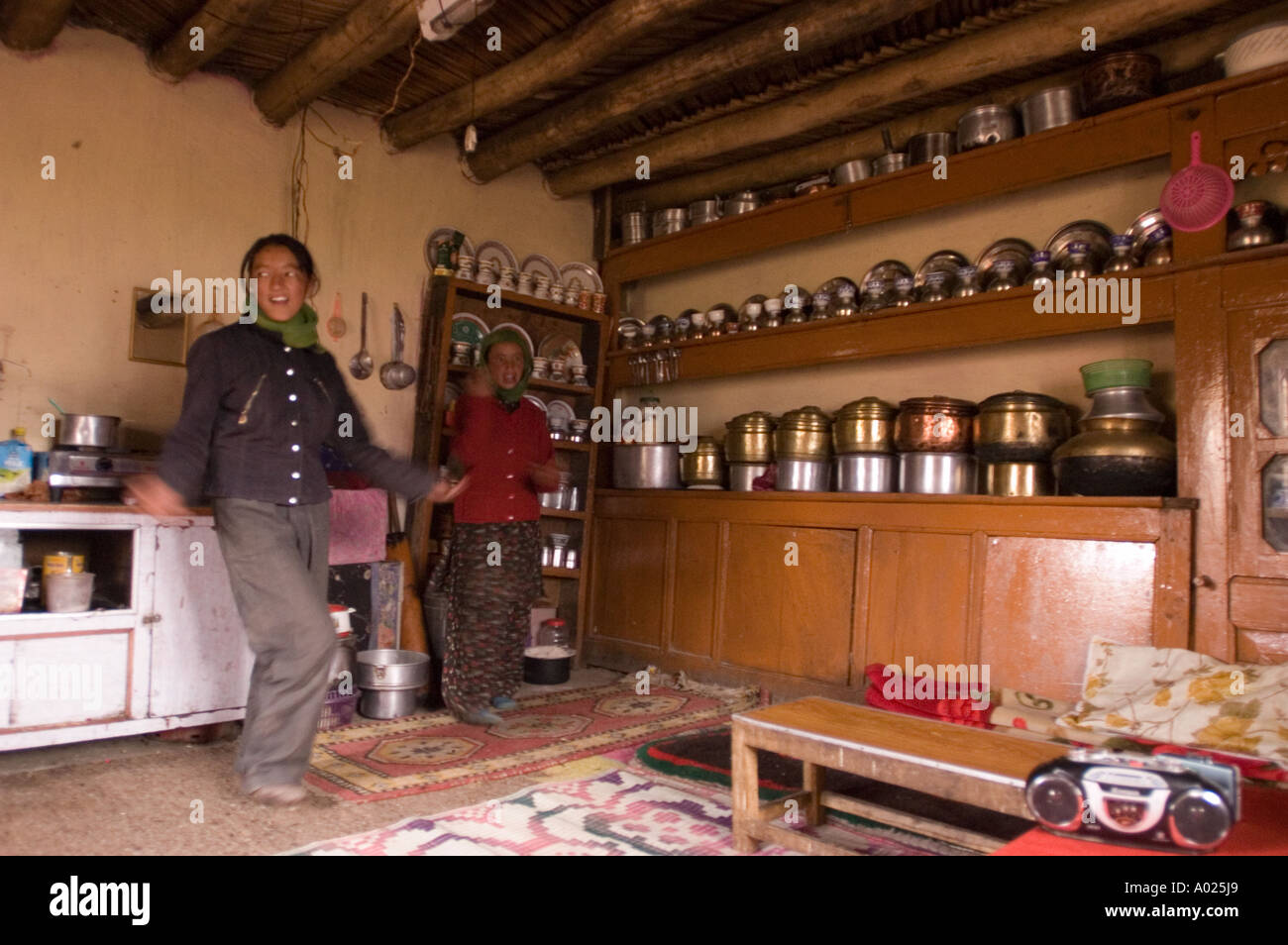 Ladakhi girl dancing inside traditional Ladakhi kitchen Rupshu valley ...
