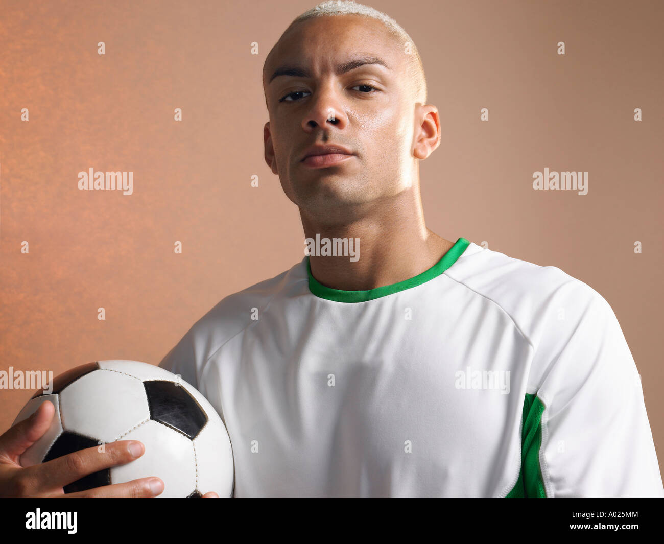Football player holding ball, portrait Stock Photo Alamy