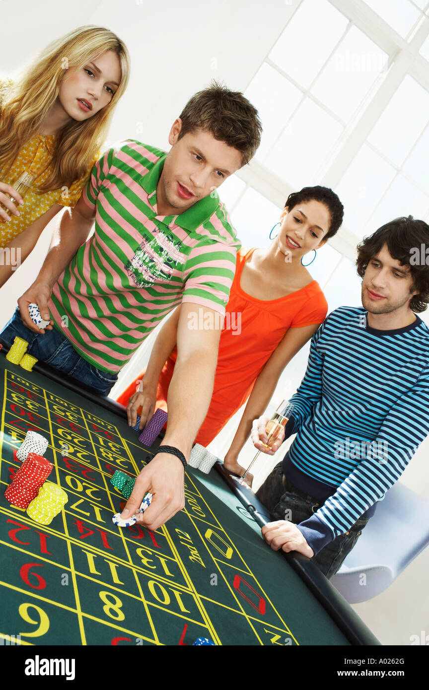 Friends Gambling on roulette table Stock Photo