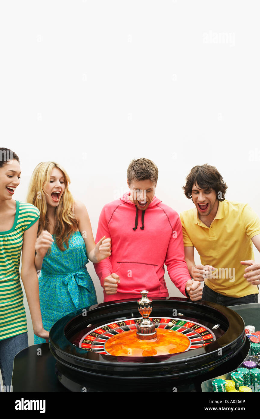 Group of friends winning on roulette wheel Stock Photo
