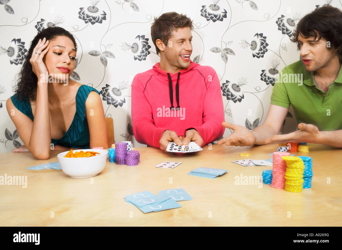 Friends Playing Cards, man showing winning hand Stock Photo