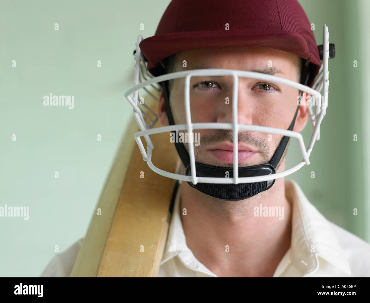 Cricket player wearing helmet and holding bat, close-up, portrait Stock Photo