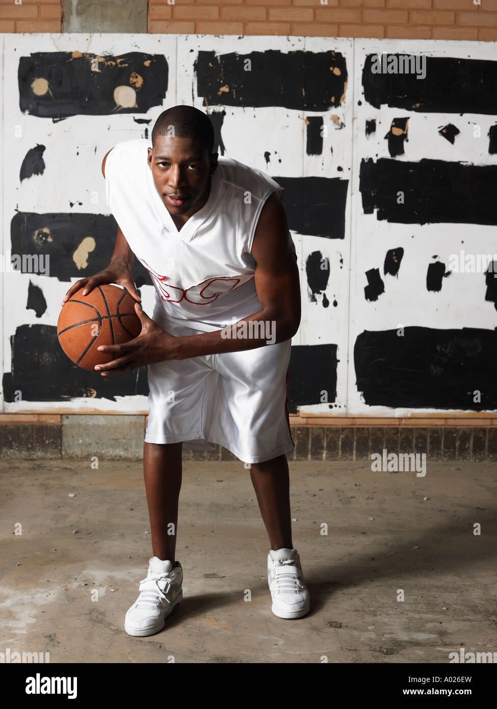 Basketball player holding ball, portrait Stock Photo - Alamy