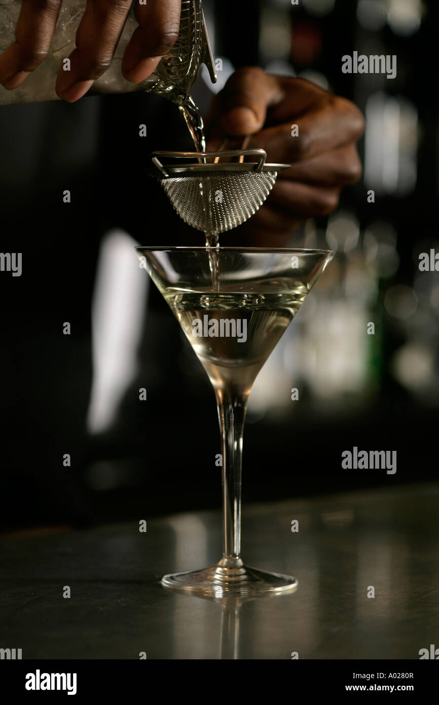 Bartender pouring a drink on a bar Stock Photo