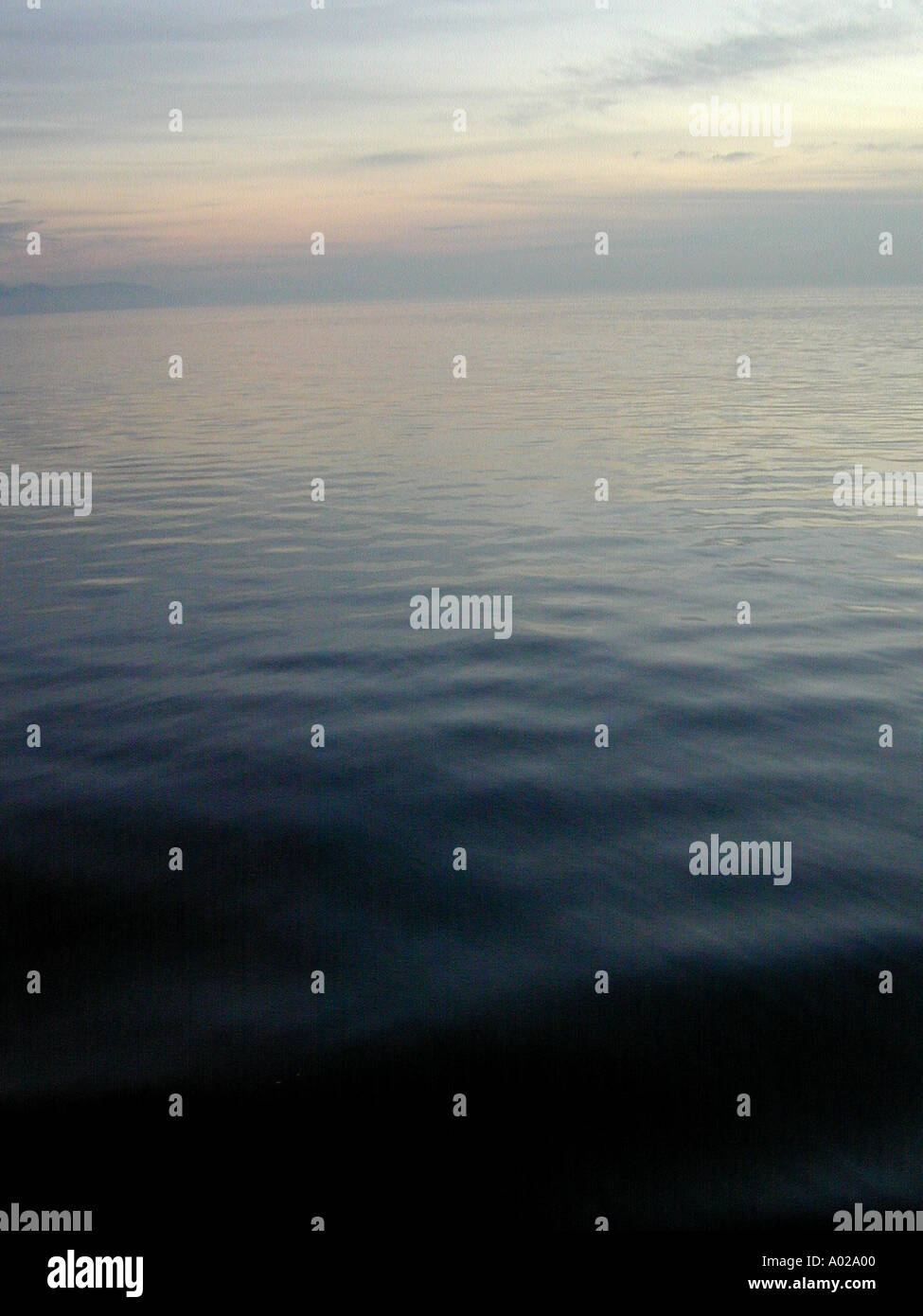 A calm gray day on Puget Sound in Washington State viewed from a Washington State ferry traveling between Clinton on Whidbey Is Stock Photo