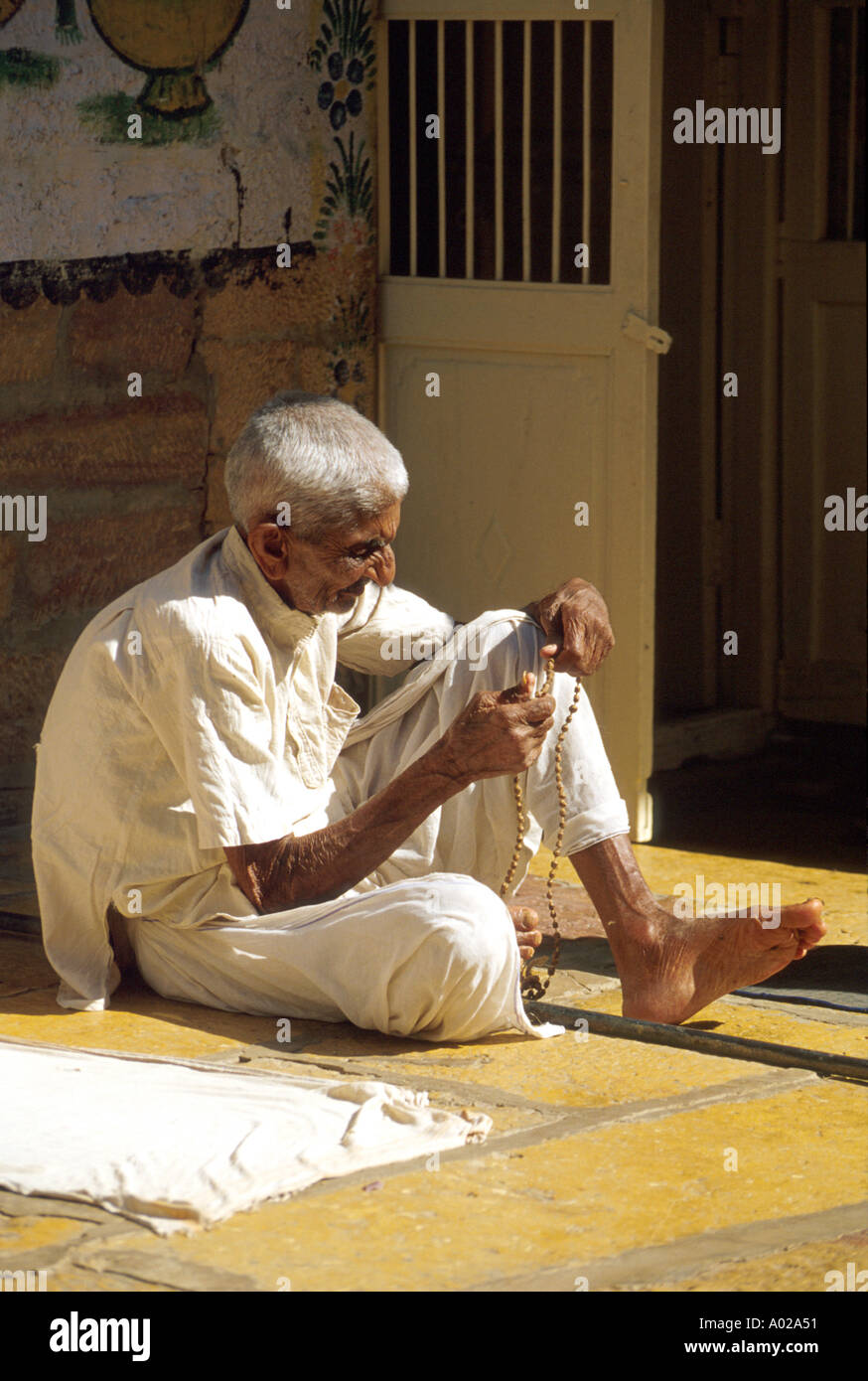 Indian Man Counting Beads, Udaipur, Rajasthan, India Stock Photo