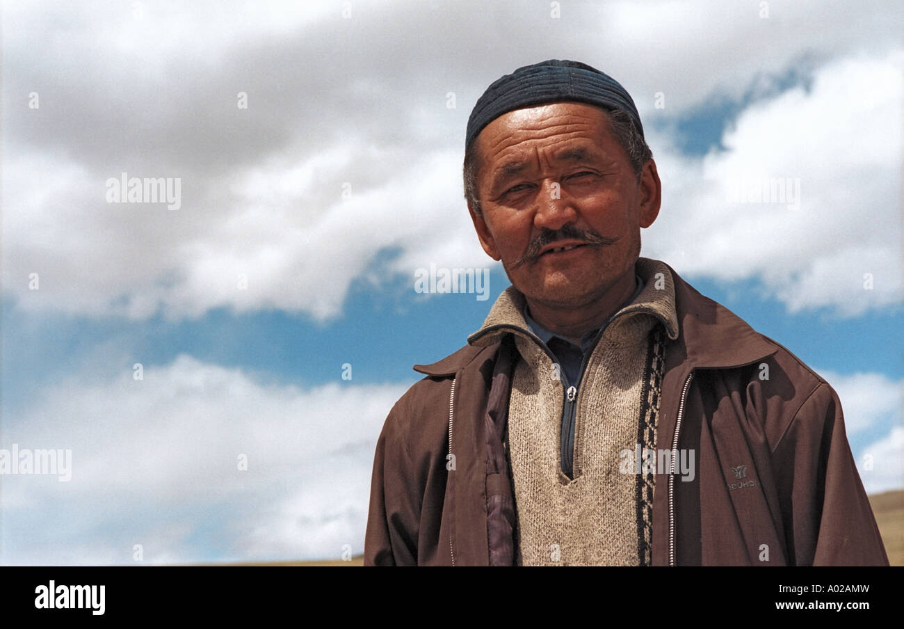 Portrait of a Mongolian Kazakh man. Mongolian custom house Red Yurt nearby. Border between Russia and Mongolia Stock Photo