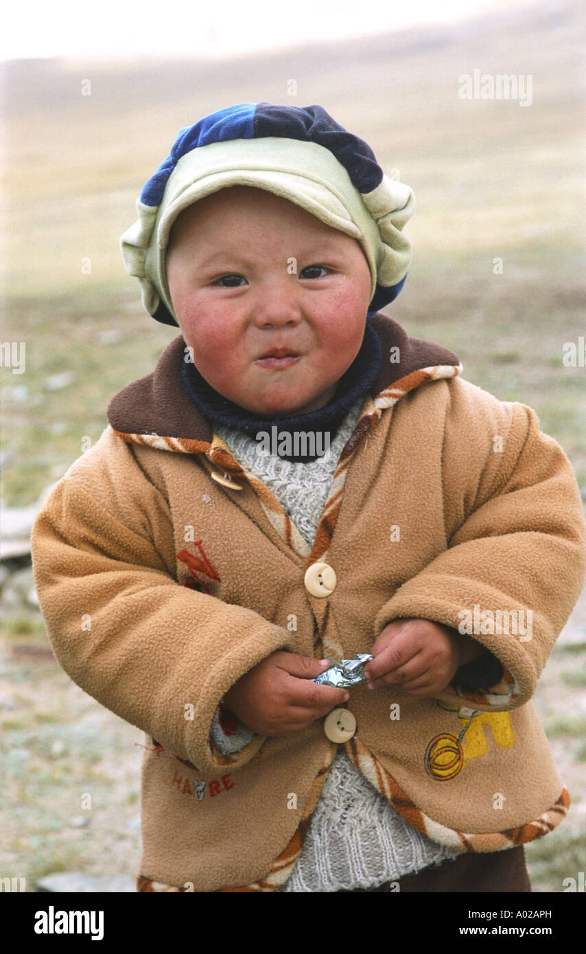 Portrait of a baby with a candy. The Durbet Daba Pass. Border between Russia and Mongolia Stock Photo