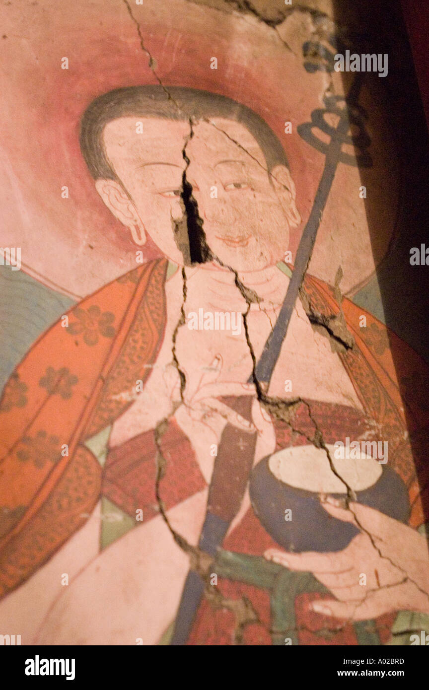Cracked mural of Marpa Translator at Hemis Drukpa Kagyu monastery, Ladakh, Kashmir, India. Ancient Buddhist wall art showing visible damage. Stock Photo