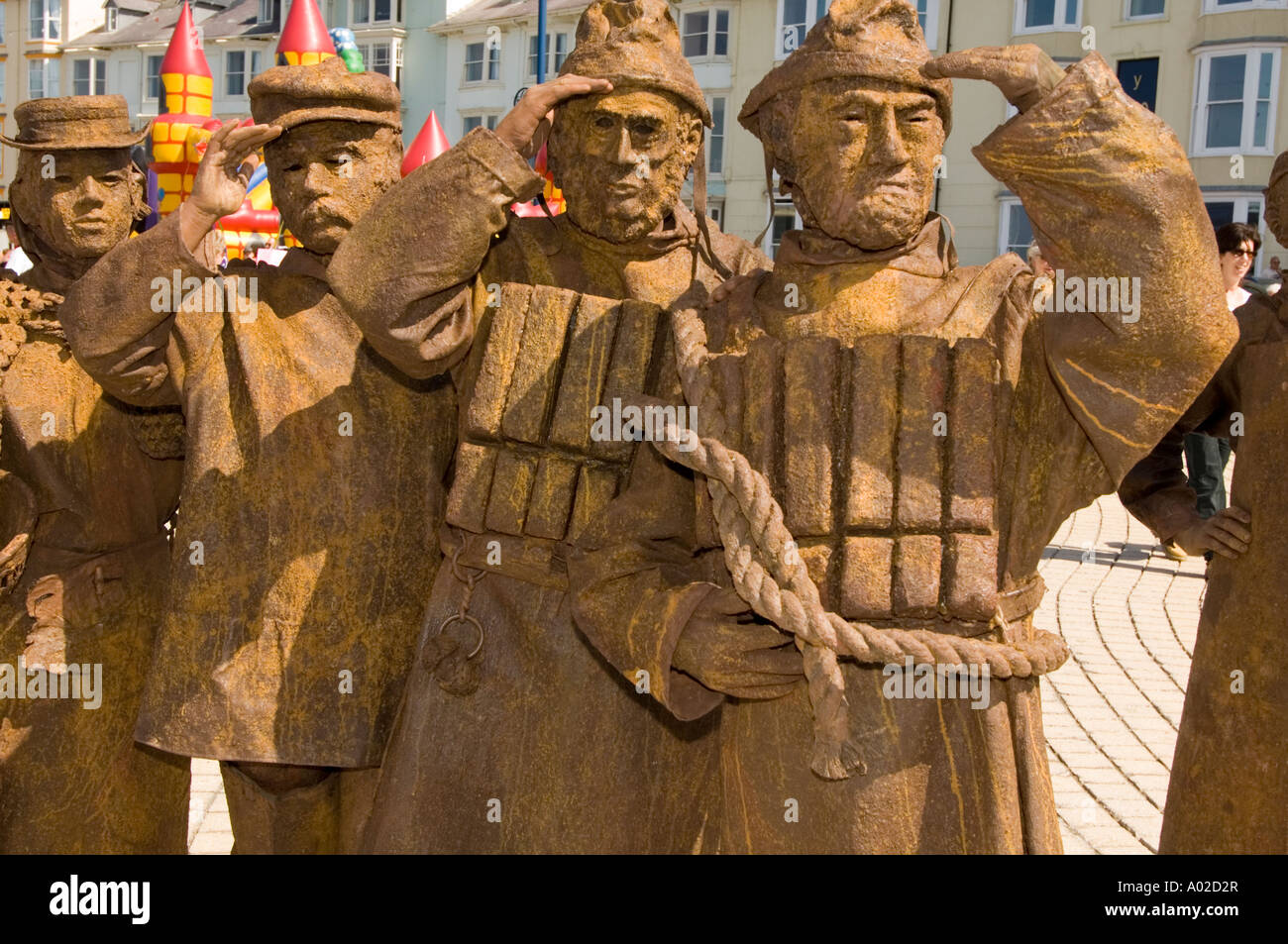 Street entertainers The Strangelings perform as moving bronze seafaring statues on Aberystwyth promenade Wales UK Stock Photo