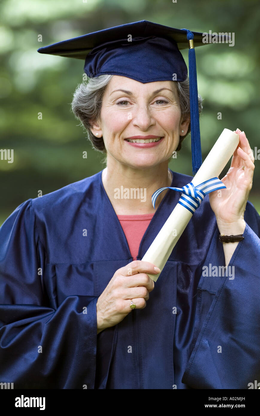 Senior woman collage graduate smiling with diploma Stock Photo