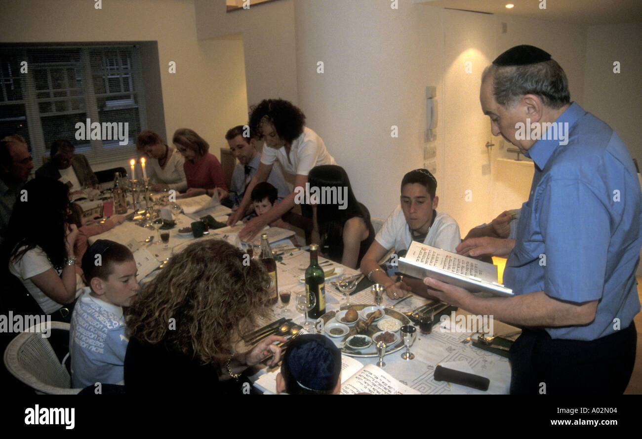 Jewish passover with the head of the family reading from the Haggadah London Stock Photo