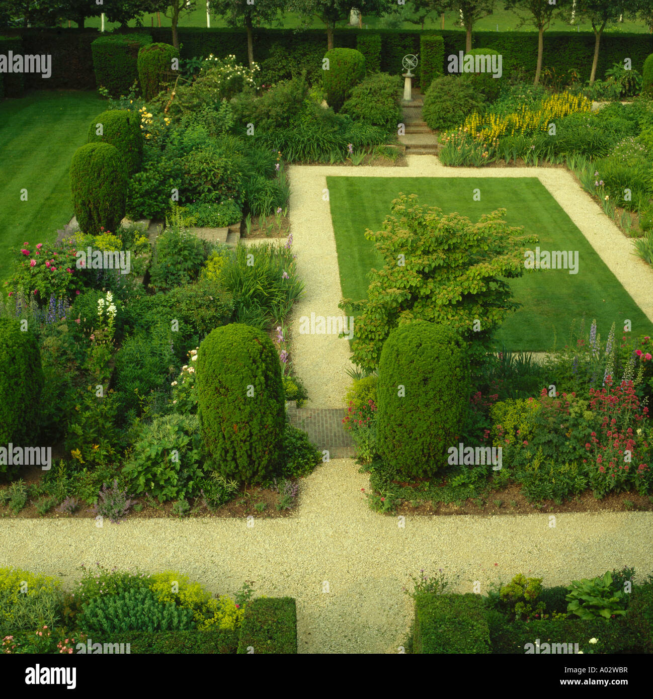 Aerial view of small rectangular lawn with gravel paths edged with mixed borders with structure Stock Photo