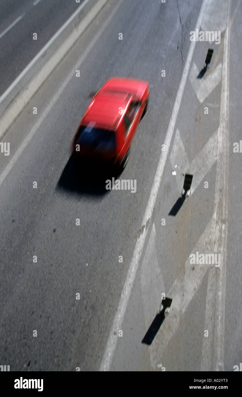 Red car driving on highway Stock Photo