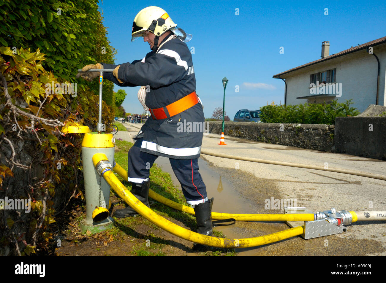 Firefighter at the hydrant Stock Photo