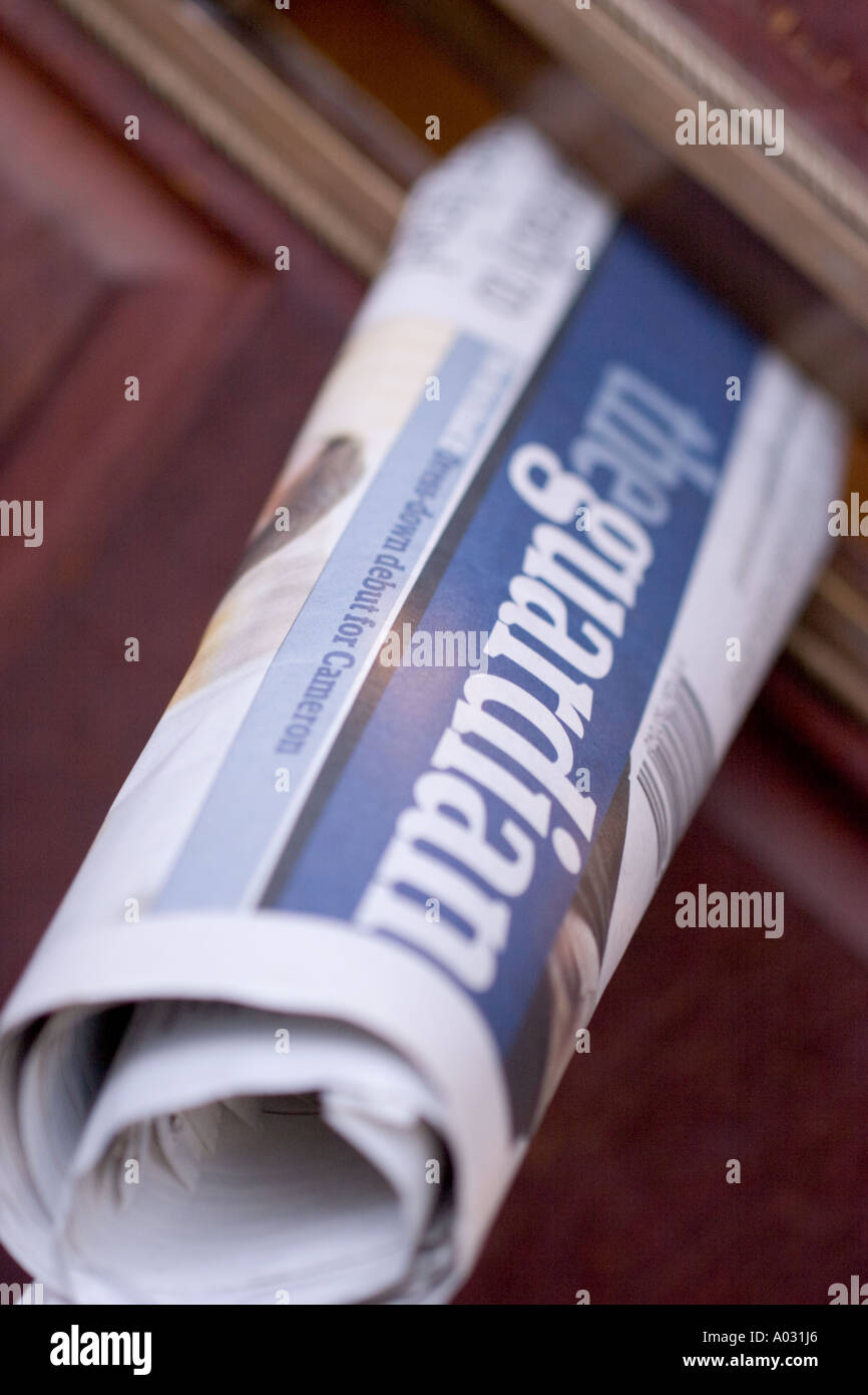 Guardian Newspaper being delivered through letterbox Stock Photo Alamy
