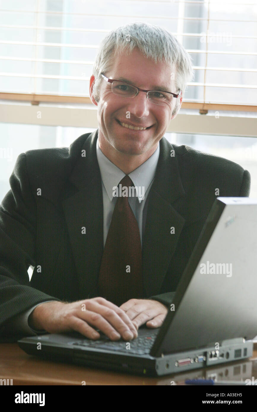 Businessman smiling at computer hi-res stock photography and images - Alamy