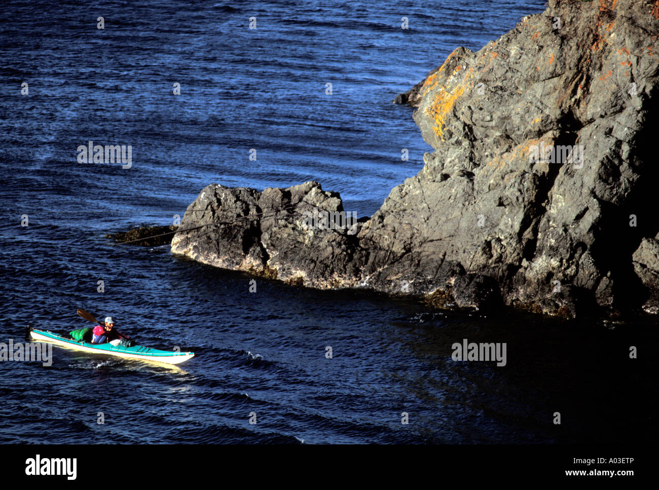 Stock image of a man in a sea kayak in Whale Cove Grand Manan Island