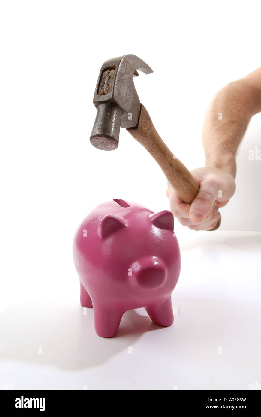 Hammer smashing piggy bank to extract savings Stock Photo - Alamy