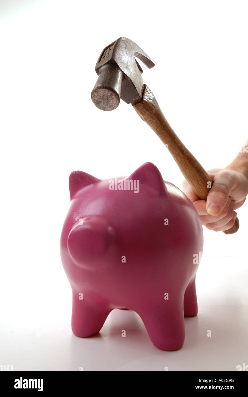Hammer smashing piggy bank to extract savings Stock Photo - Alamy