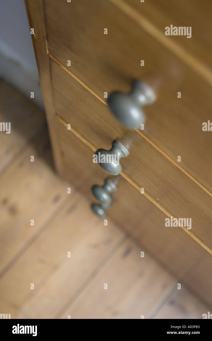 A Close Up Of The Handles On A Wooden Chest Of Drawers Shot From