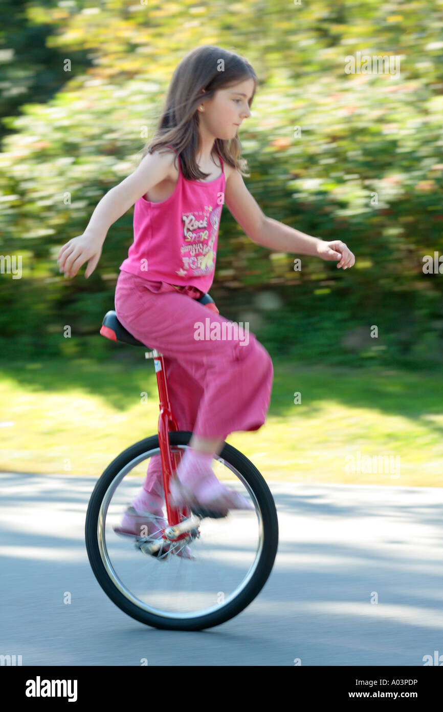 young girl riding a unicycle Stock Photo Alamy