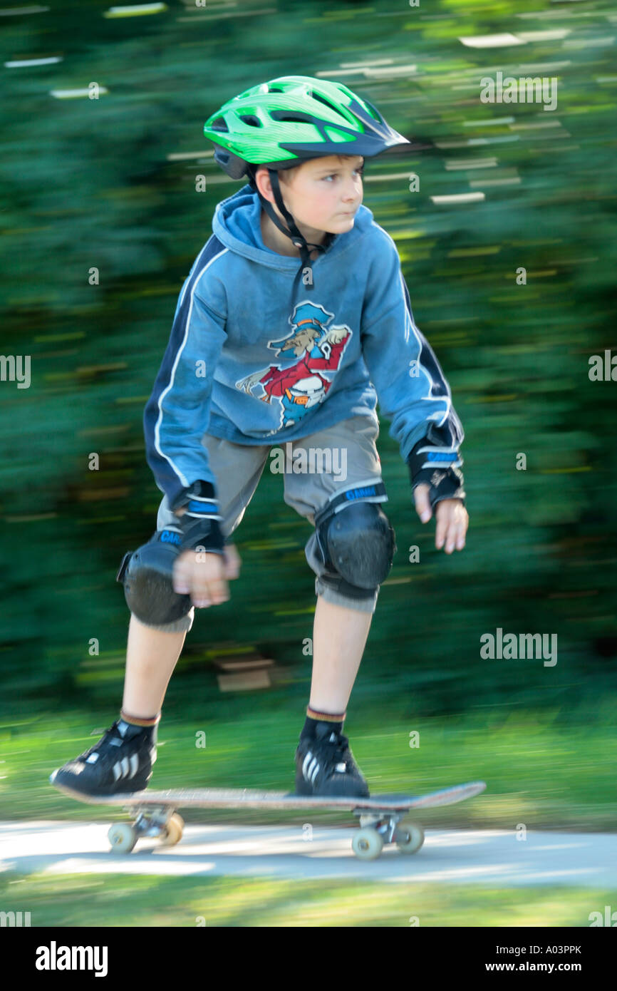 young skater skating with pads and helmet Stock Photo