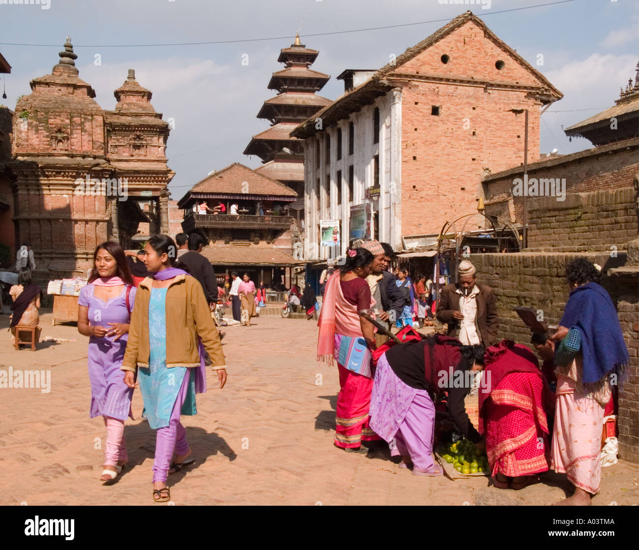 Local people in a street scene. Taumadi Square Bhaktapur Kathmandu Valley Himalayas Nepal Asia Stock Photo