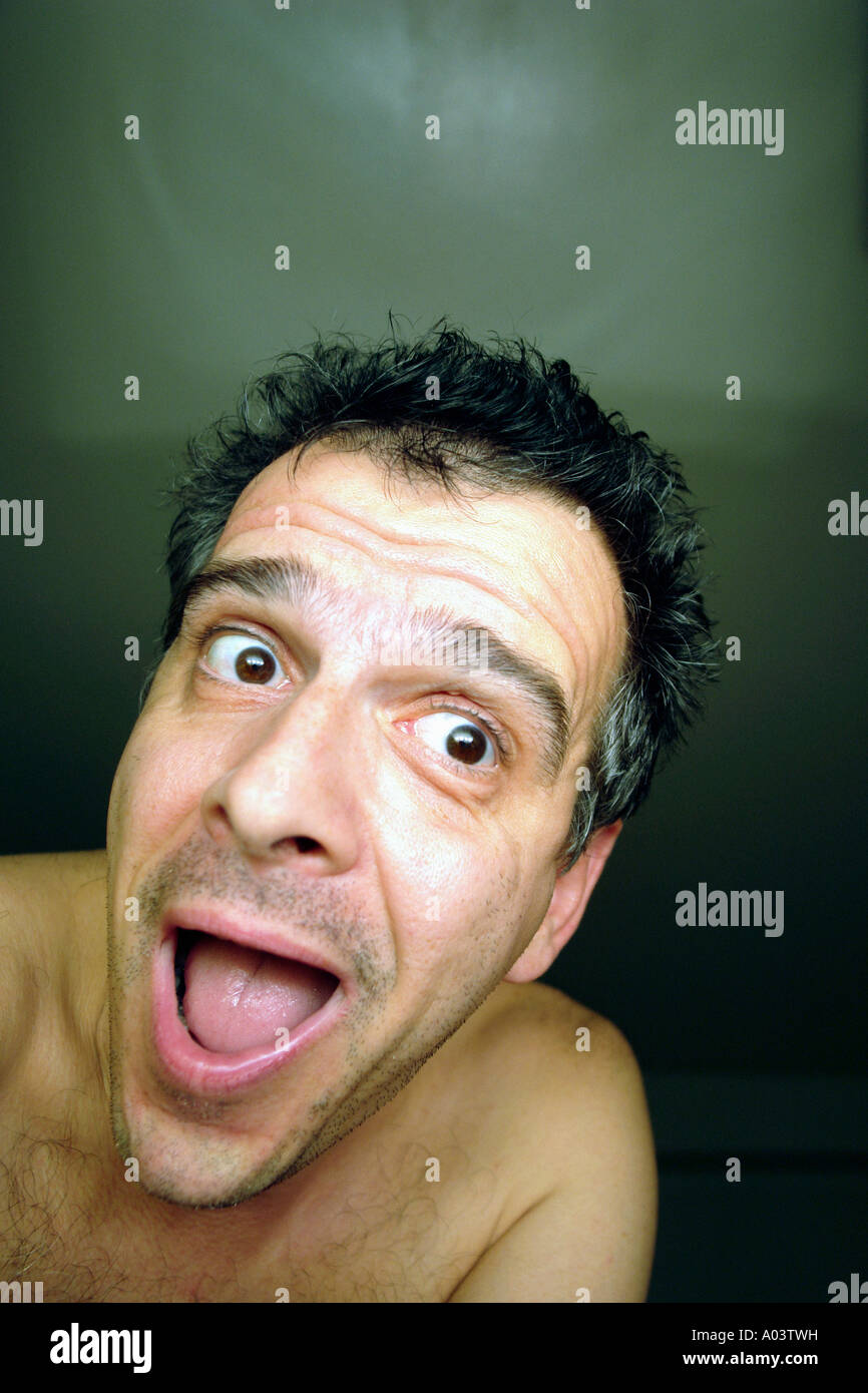 Man Looking Into Camera Lens and Making a Funny Expression His Mouth is Open Copy Space Stock Photo