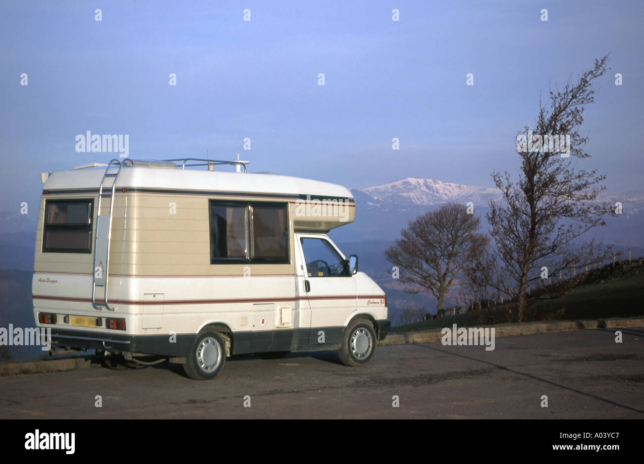 VW Volkswagen RV Auto Sleepers camper van motorhome winter touring in Snowdonia National Park snow capped mountains at Nebo Gwynedd North Wales UK Stock Photo