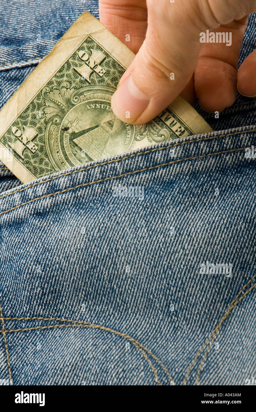 hand taking a dollar bill out of the back pocket of a pair of jeans Stock Photo