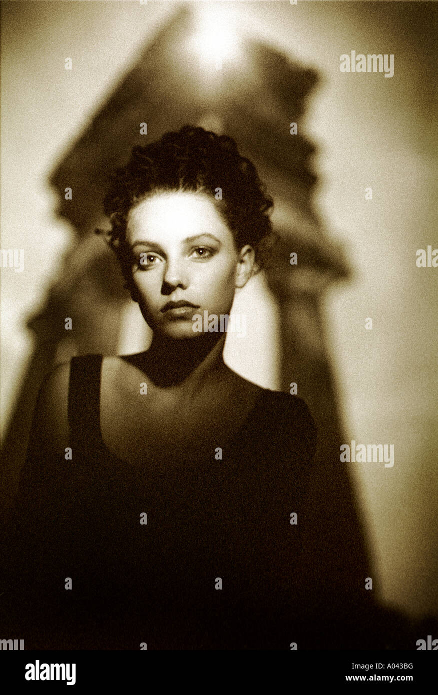 A model poses in front of a projected image in the studio. Stock Photo