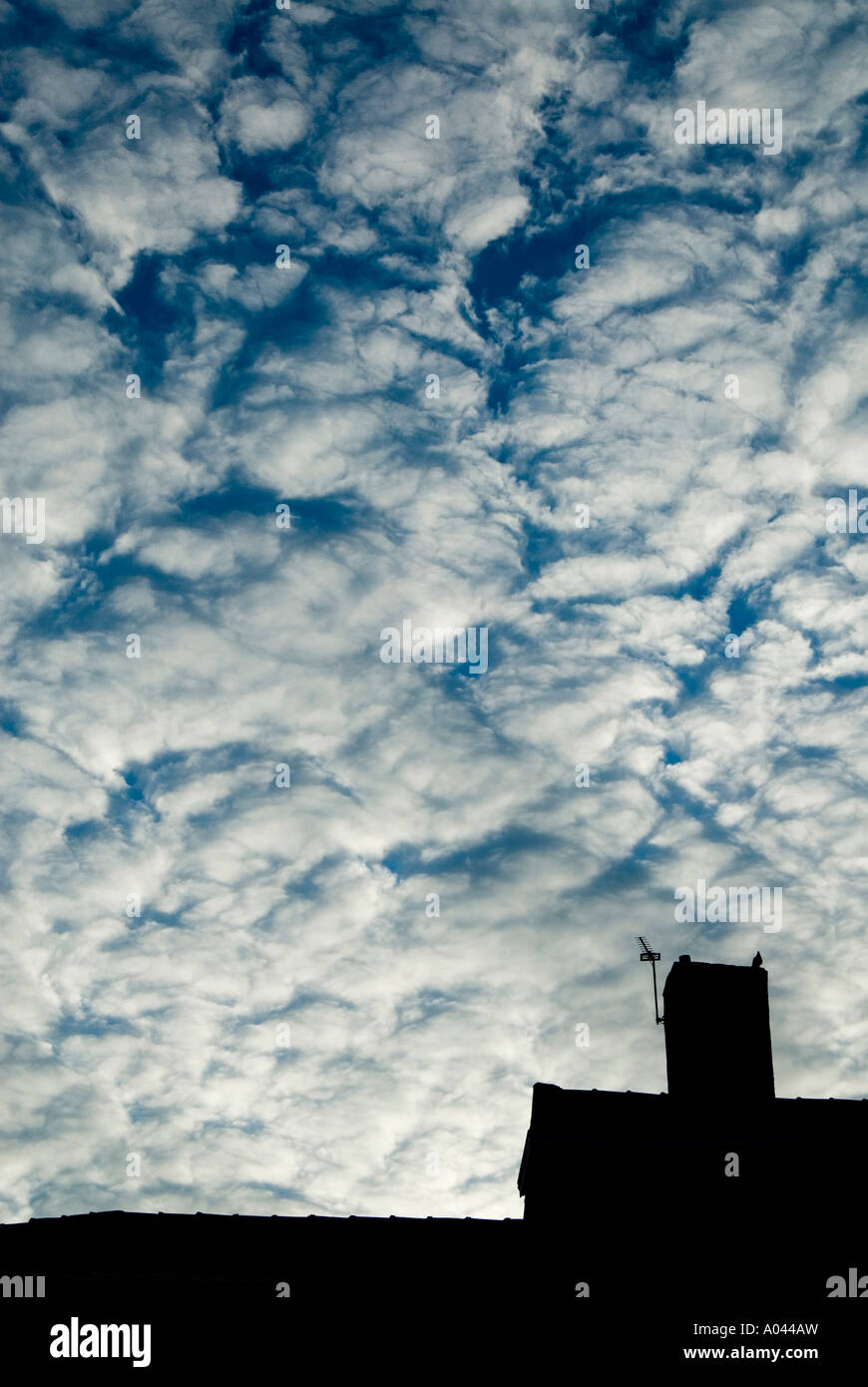 Silhouette of a house chimney against a dramatic cloudy sky Stock Photo ...