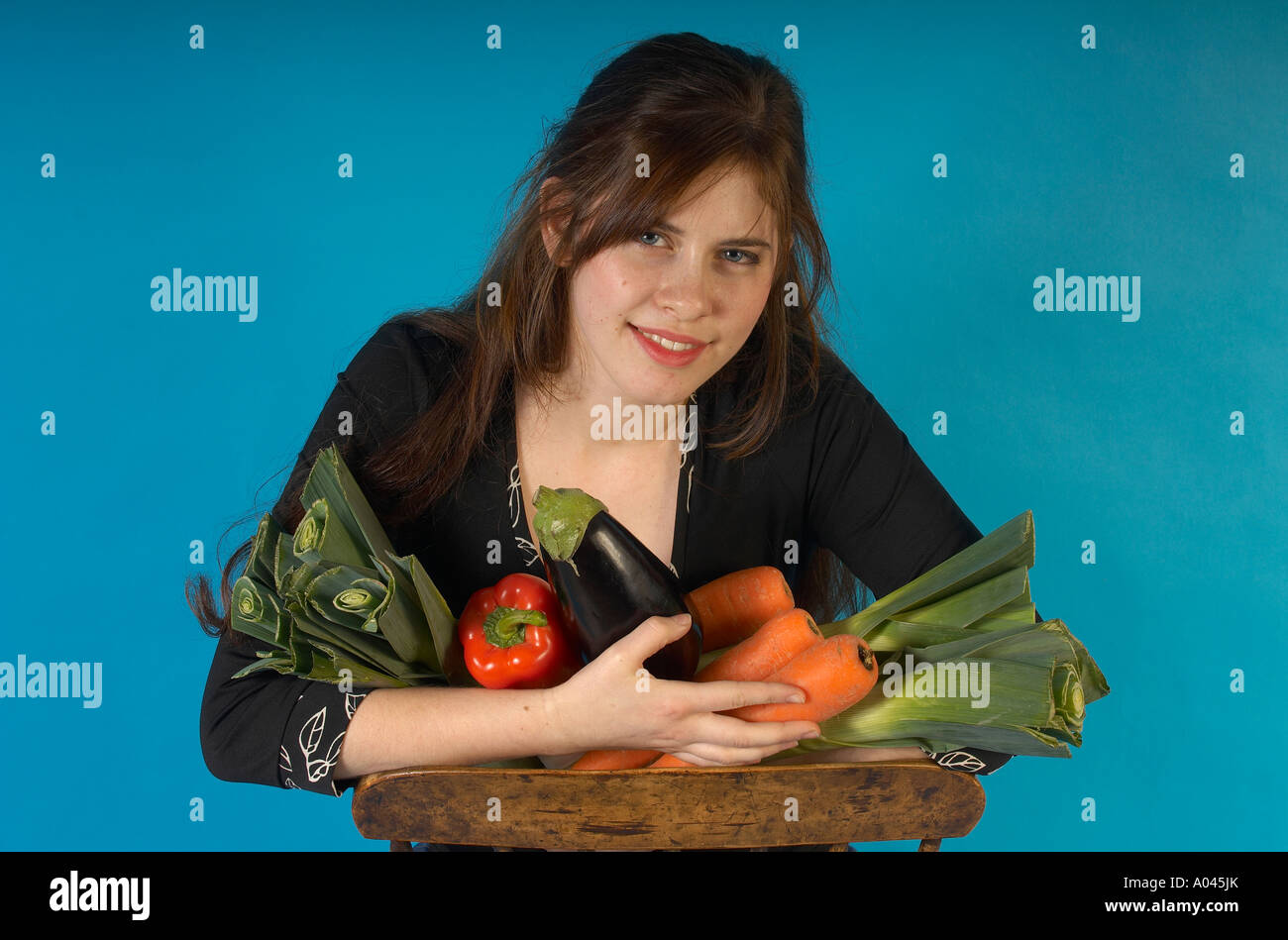 Young woman holding fresh vegetables Stock Photo