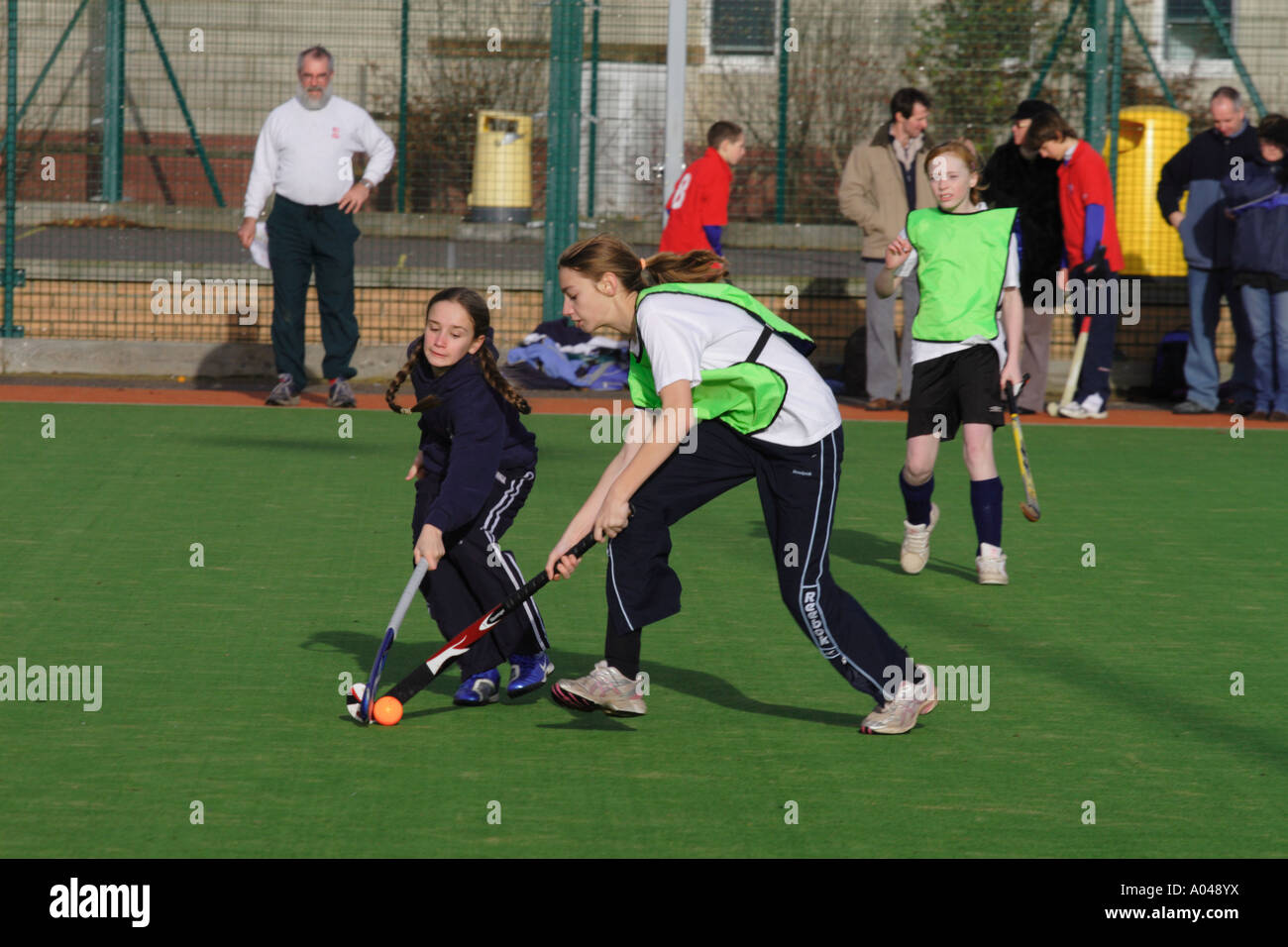 Youth field hockey match mixed gender with both boy and girl team players Stock Photo