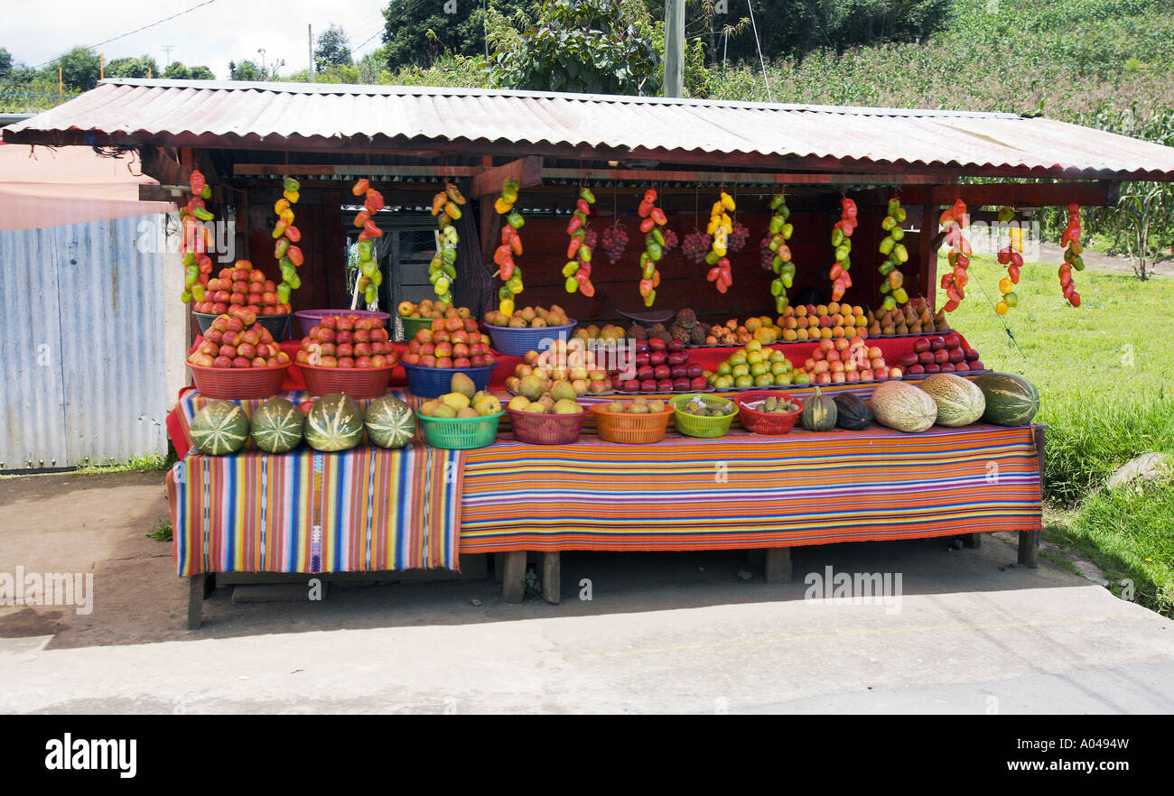 GUATEMALA Roadside market selling apples melons and vegetables in the northwestern highlands of Guatemala Stock Photo