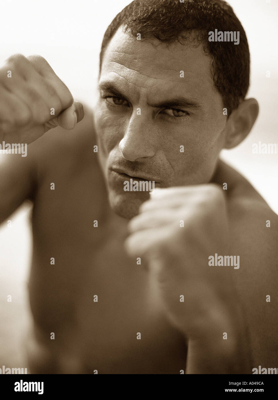 Portrait of male boxer with fists clenched ready to fight Stock Photo